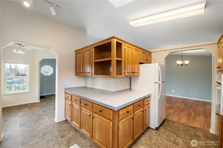 Warm wood kitchen cabinetry glowing in soft natural light, creating a cozy and inviting atmosphere in the heart of the home.