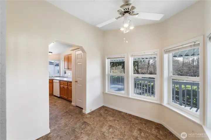 From another angle, the window-lined breakfast nook reveals sweeping river views and soft natural light that fills this calm, welcoming space.