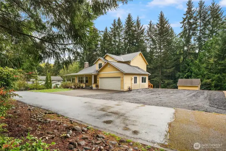 Expansive driveway parking on both sides of the home allows for extra space for RV, boats, & trailers