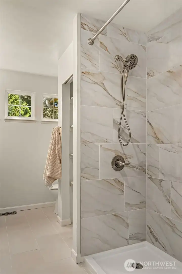 Custom tile floor & shower enclosure in primary bathroom!