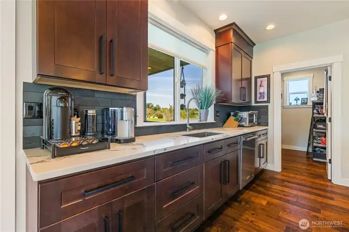 Beautiful custom cabinetry and corian countertops, large picture window with view of the golf course brings in plenty of light. What a joy to cook in this kitchen! Beautiful custom cabinetry and corian countertops, large picture window with view of the golf course brings in plenty of light. What a joy to cook in this kitchen!