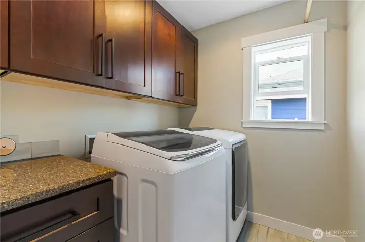 Upstairs laundry room with lots of cabinet storage and countertop for folding. Overhead hanging bar also added. Upstairs laundry room with lots of cabinet storage and countertop for folding. Overhead hanging bar also added.