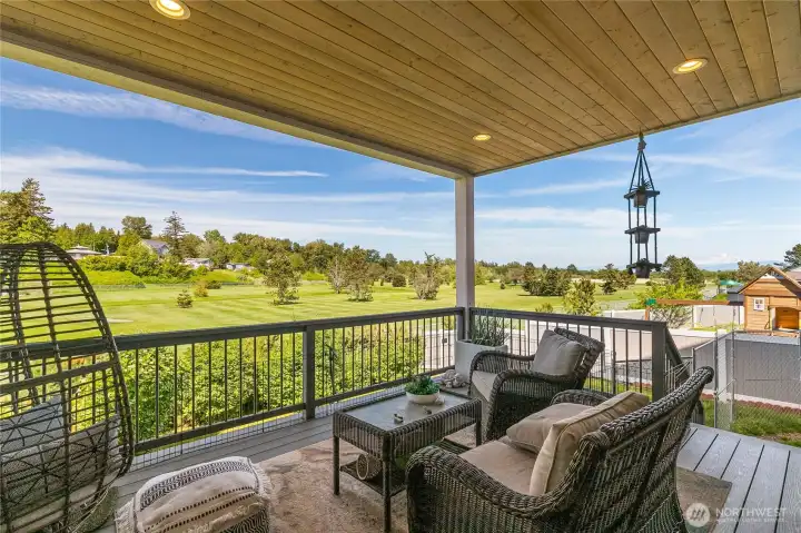 Rear covered deck with wood ceiling and lighting. Relax out here and enjoy the greenery views of the golf course. Rear covered deck with wood ceiling and lighting. Relax out here and enjoy the greenery views of the golf course.