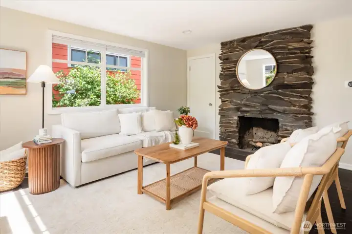 Large picture windows frame mature landscaping.