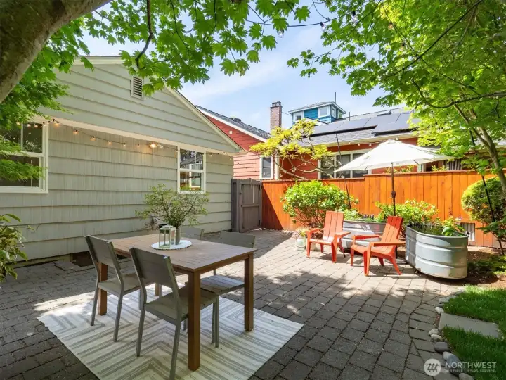 Backyard oasis with large patio, established trees and shrubs, plenty of room to entertain, relax, or play.