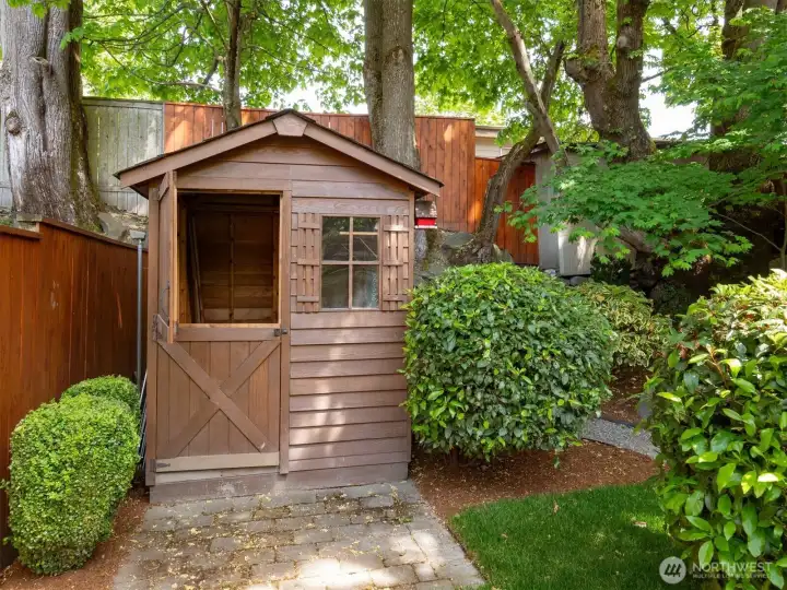 Garden shed with new roof, perfect for storage or a playhouse.