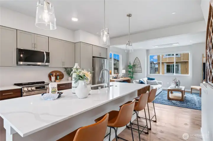 Large kitchens with entertainment islands, designer pendant lighting and luxury cabinet packages. Photos are of model home in the community.