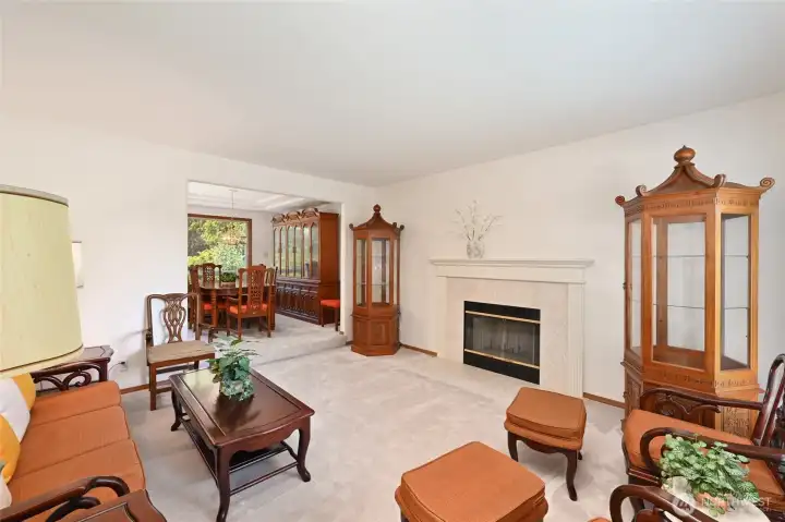 Sunken living room has traditional fireplace with marble surround Sunken living room has traditional fireplace with marble surround