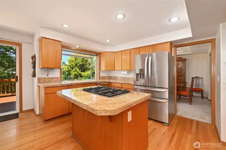 Oak and granite in light & bright kitchen with a garden window Oak and granite in light & bright kitchen with a garden window