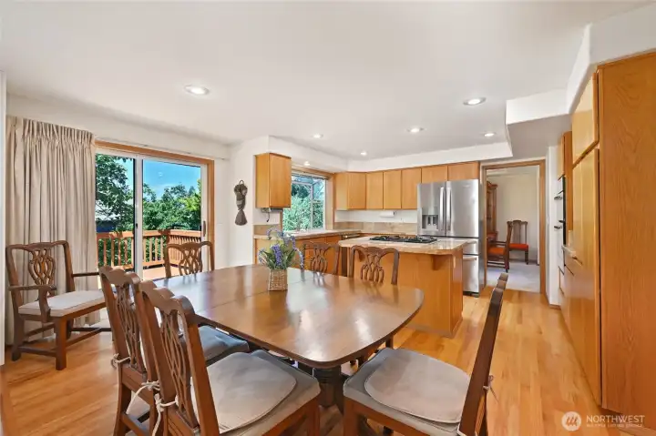 Dining and kitchen area with oak cabinetry, stainless appliances, gas cooktop island, granite countertops Dining and kitchen area with oak cabinetry, stainless appliances, gas cooktop island, granite countertops