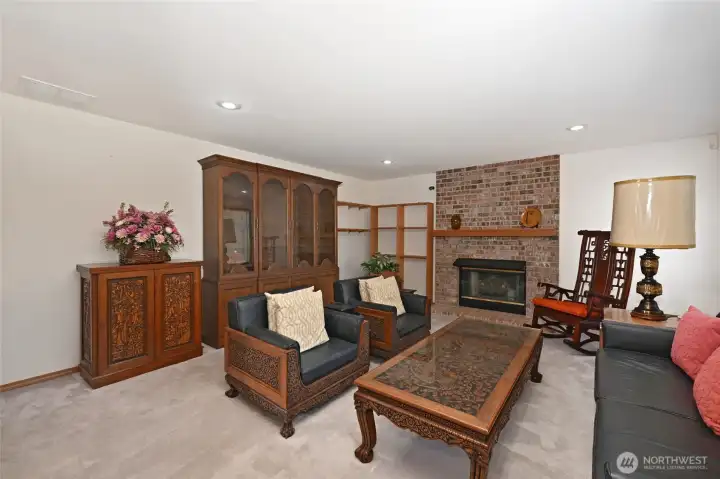 Family room has gas fireplace with brick surround Family room has gas fireplace with brick surround