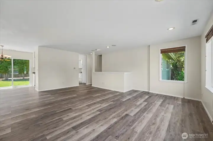 Living room areas with stairwell leading to basement.