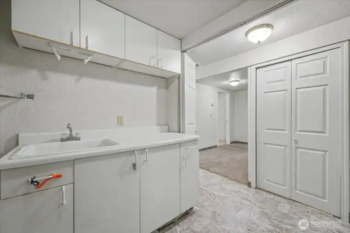 Utility room included sink and plenty of storage.