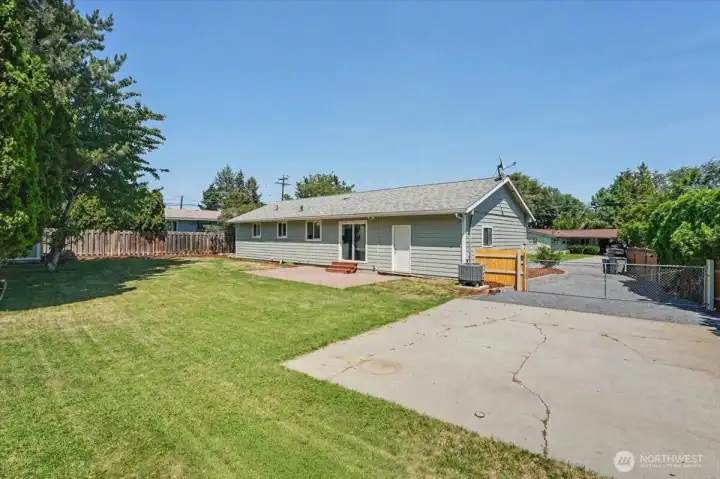Large concrete area in backyard.
