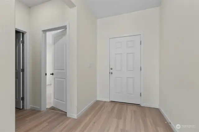 Entry has a closet to one side, a full bedroom and full bathroom are off this hallway.