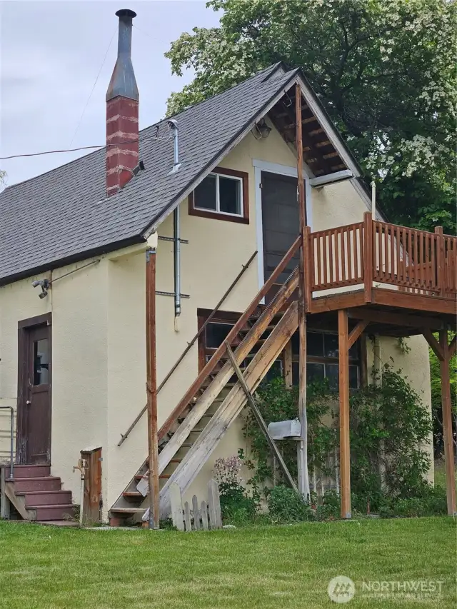 Behind garage and upper living space