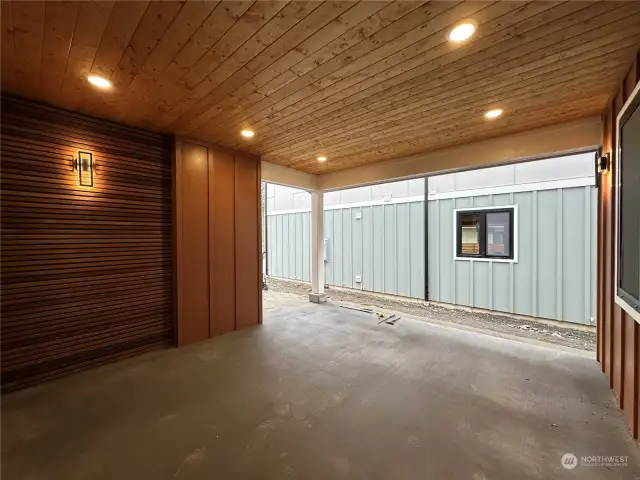 Large covered patio is private and features a beautiful wood feature wall. This is a space that could be used year-around. Fence & landscaping not installed yet.