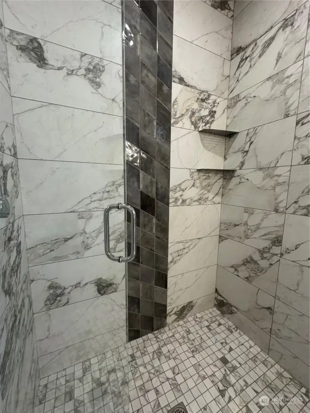 Close up for custom tiled shower with shelving