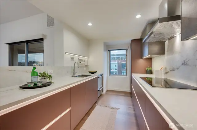 Stunning custom kitchen with every detail in mind; Fisher Paykel stainless steel appliances, induction cooktop, solid stone countertops by Neolith, cabinetry by Bauformat & wine cooler from Zephyr.