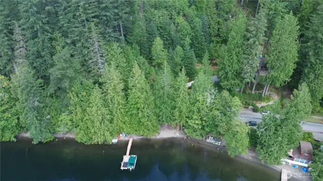 House Tucked in Trees Behind Road- Just Steps Away from Your Private Beach.