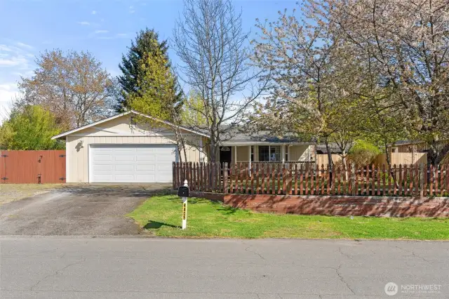 Front Exterior-Charming curb appeal with fenced yard and covered front porch.