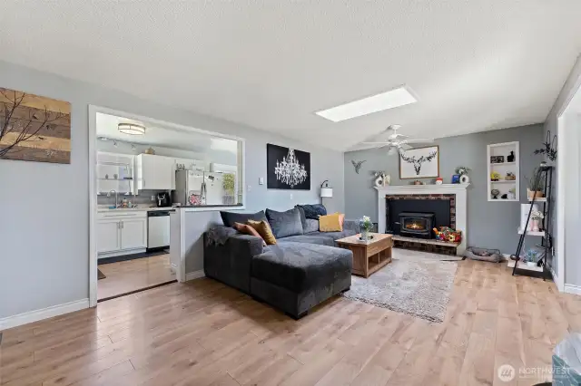 Open living space with fireplace and natural light.