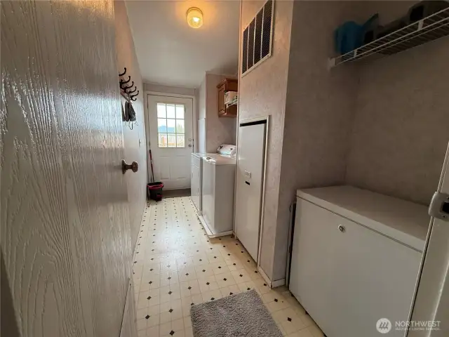 Laundry-room with Freezer space and door to back patio