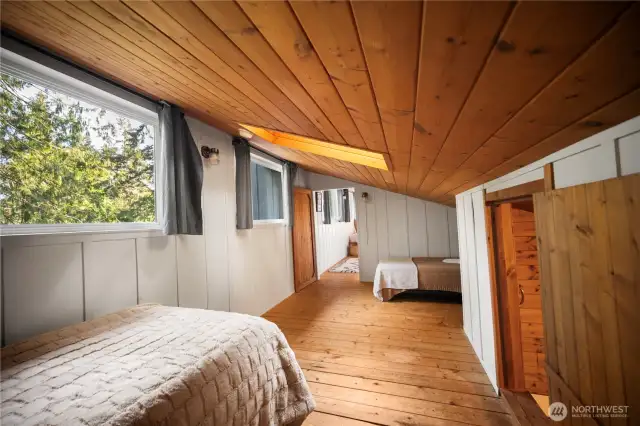 Bathe in natural light and enjoy serene views from this cozy loft. Reading nooks a plenty, and even a surprise closet nook. Slight views of Case Inlet through the trees. There is access to one of the private beaches right across the street.