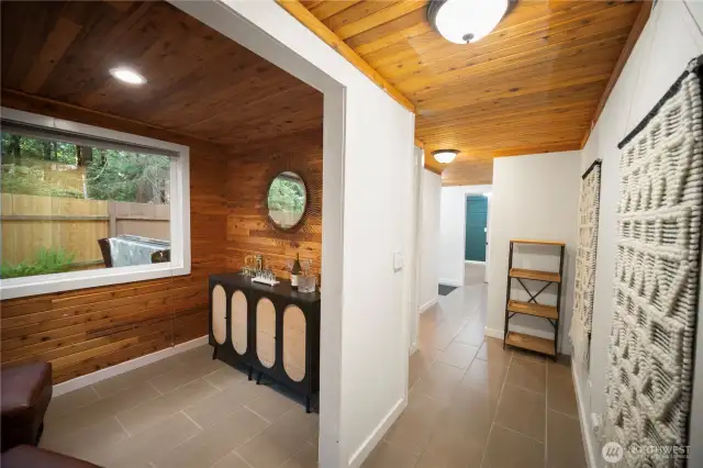 You can see the open hot tub through the window. Down the main-level hall to check ou tthe bathroom and kitchen.