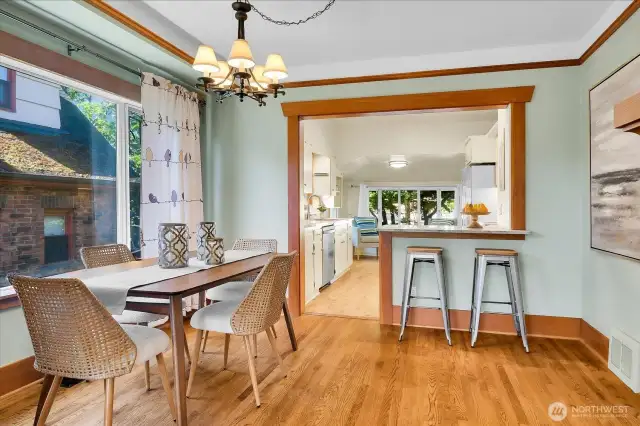Pretty honey-colored oak floors and a view into the kitchen from the dining room.