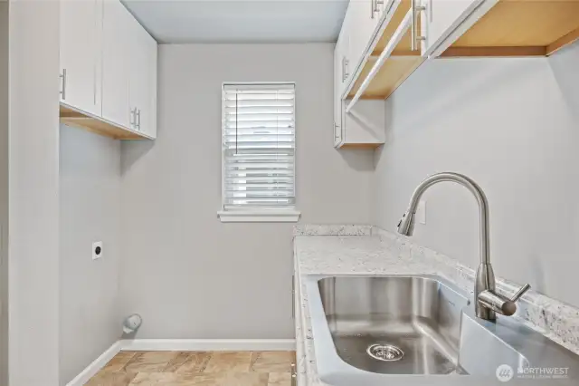Large laundry room with plenty of countertop and storage space