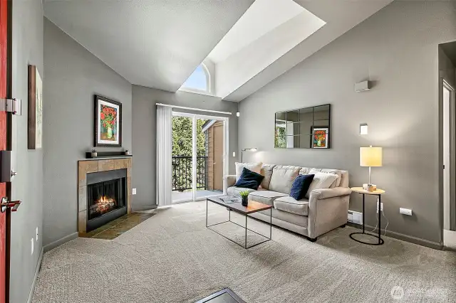 Light and bright living space with a skylight and cozy wood burning fireplace