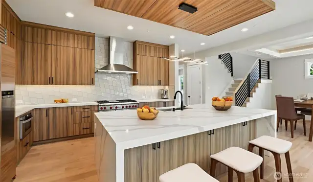 Enviable gourmet kitchen boasts lux appliances, such as 48" Subzero Refrigerator, Wolf Double-Oven, 6-Burner & Griddle Range, 48" Zephyr Pro Wall Hood, Sharp Microwave Drawer, Cover Dishwasher, and all anchored by an oversized waterfall island. Vrtually staged.