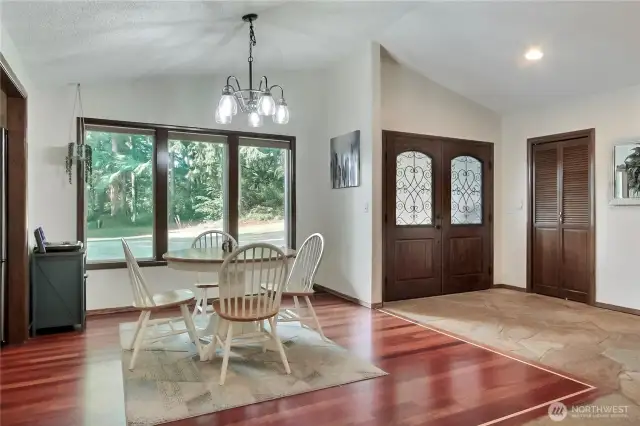 Formal dining area adjacent to the double door entry with large windows connecting you to the outdoors.