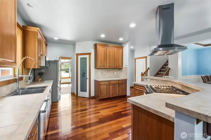 This Chef's Kitchen features a stunning stainless hood & gas cooktop.