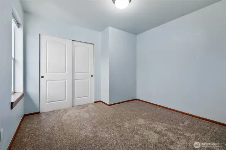 Bedroom #4 is located at the top of the stairs and overlooks the side yard.