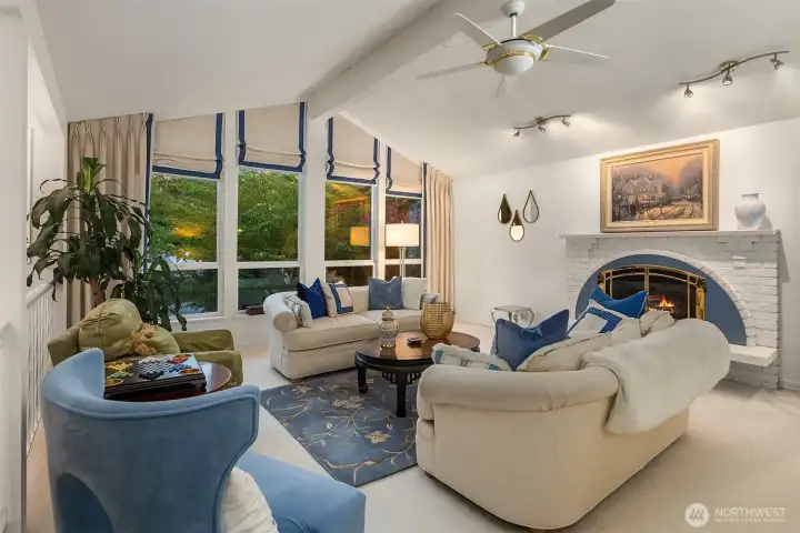 This living area exudes harmony and refinement—an ideal blend of sophistication and ease. A perfect spot to unwind by the fire or enjoy the glow of the treetops outside the soaring windows.