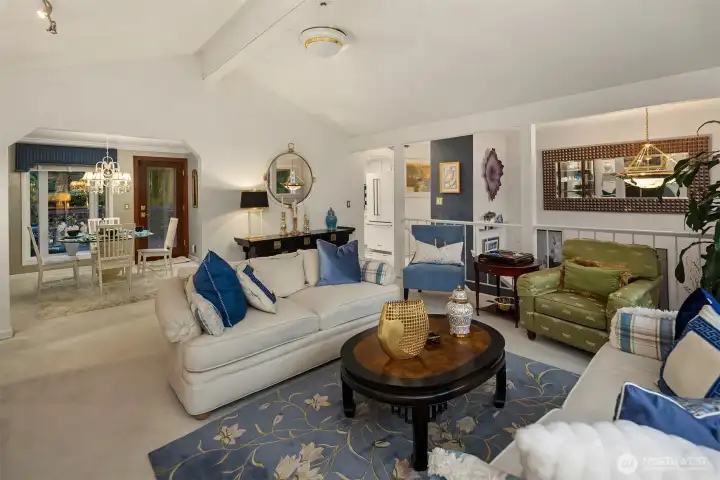 Beautifully balanced with clean lines and mid-century inspiration, this space highlights exposed beams, track lighting, and custom window treatments that frame tranquil garden views. Every element is designed for comfort and charm.