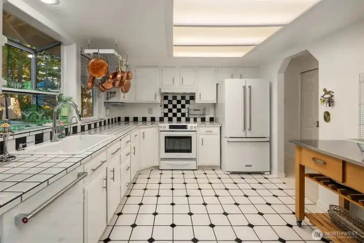 From the tiled counters and wide sink with garden window display, this kitchen blends character with functionality. Bright, inviting, and beautifully maintained—a true heart of the home. ???
