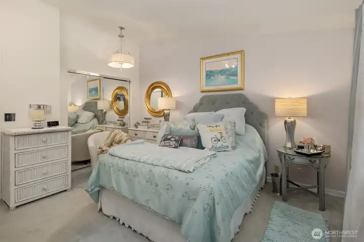 A tranquil retreat filled with soft natural light and peaceful ambiance. The primary suite features a elegant lighting evokes a sense of calm and relaxation. Mirrored closet doors add a level of sophistication. An inviting blend of comfort and elegance designed for restful nights and quiet mornings. ?????