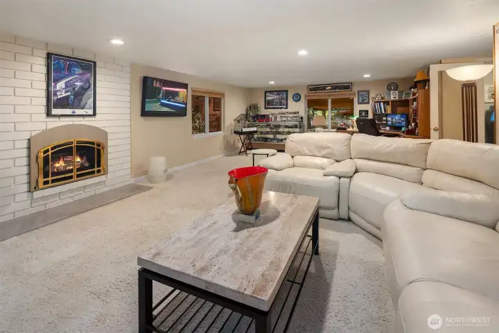 A spacious, multi-functional lower level perfect for relaxing or entertaining! The cozy gas fireplace anchors the room, while recessed lighting and generous windows keep the space bright and inviting. With ample room for a large sectional, media area, and home office or hobby zone, this flexible layout easily adapts to your lifestyle. The ideal spot for movie nights, game days, or quiet evenings by the fire. ????