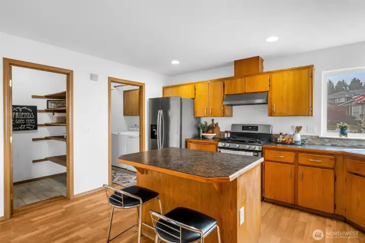 Kitchen pantry and laundry off of garage entrance.