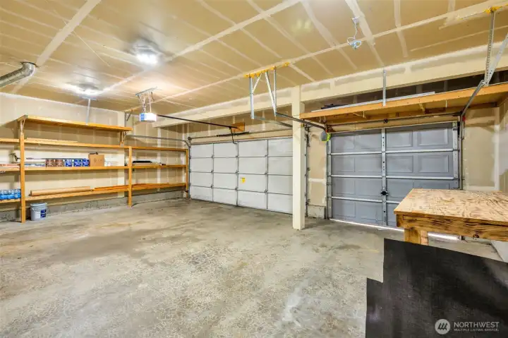 Large 3 car garage with shelving.
