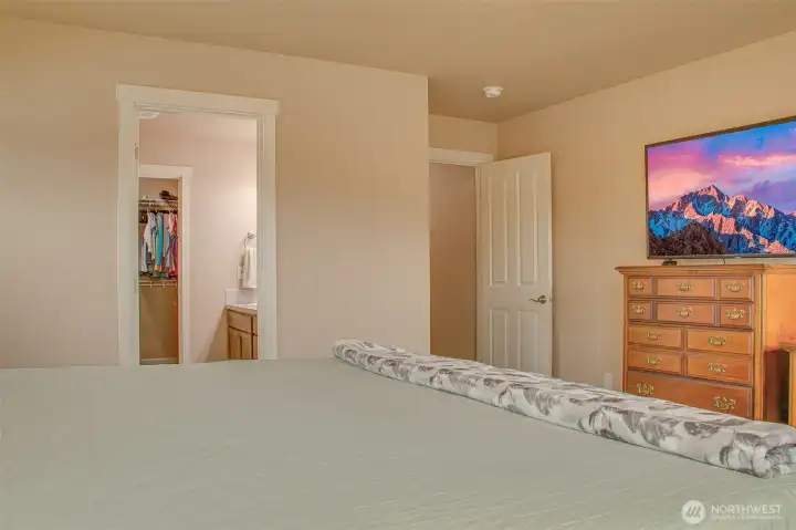 PRIMARY BEDROOM: Left to Right — Primary Bathroom with Walk-In Closet, Bedroom Door to Main Residence; Comfortably Fits King Bed and Furniture
