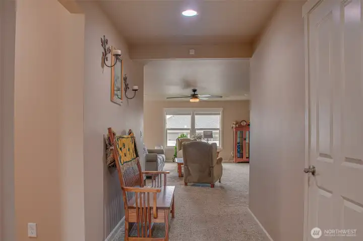 ENTRY HALL (from Front Door): Left — Hallway to Hall Bathroom, Laundry Room, and 2 Bedrooms; Ahead — Main Room with South-Facing Backyard View