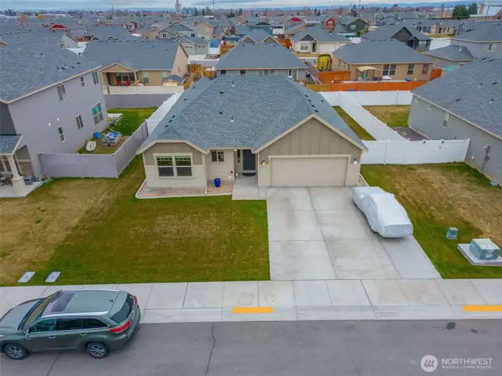 VIEW (South-Facing): Front of Home with 25' Wide Driveway for Additional Parking, 2-Car Insulated Attached Garage, and Covered Entry