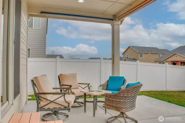 BACKYARD (from West Looking East): Covered Patio with Roller Shades — Upgraded to 270 SF; Sliding Glass Door Entry to Main Part of Residence Visible on Left
