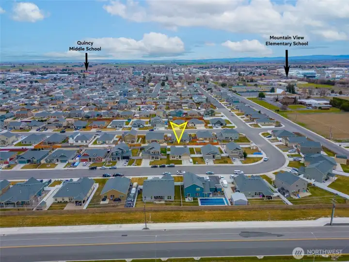 AERIAL VIEW LOOKING SOUTH: Home Sits on a Bend in the Road to the West, Naturally Slowing Traffic; Nearby Schools to the Southwest and Southeast