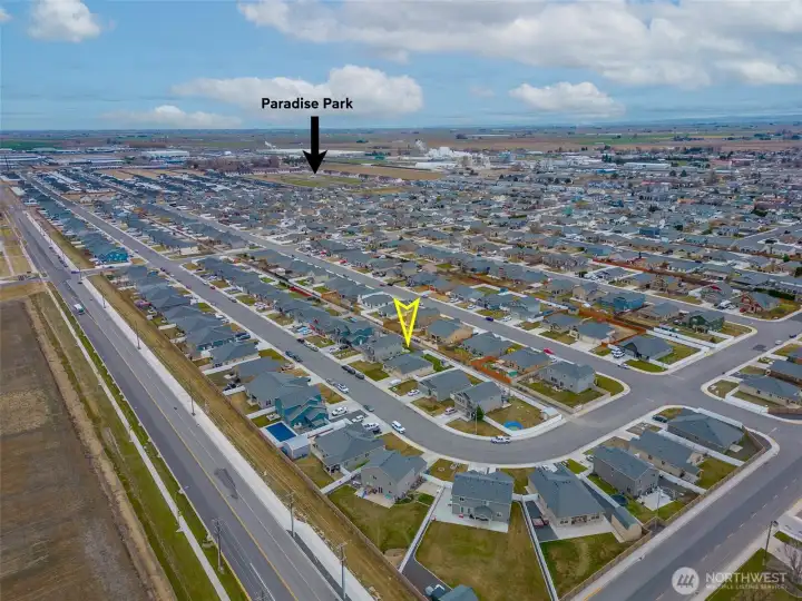 AERIAL VIEW LOOKING SOUTHEAST: Home Sits on a Bend in the Road to the West, Naturally Slowing Traffic; Nearby Park Visible to the Southeast