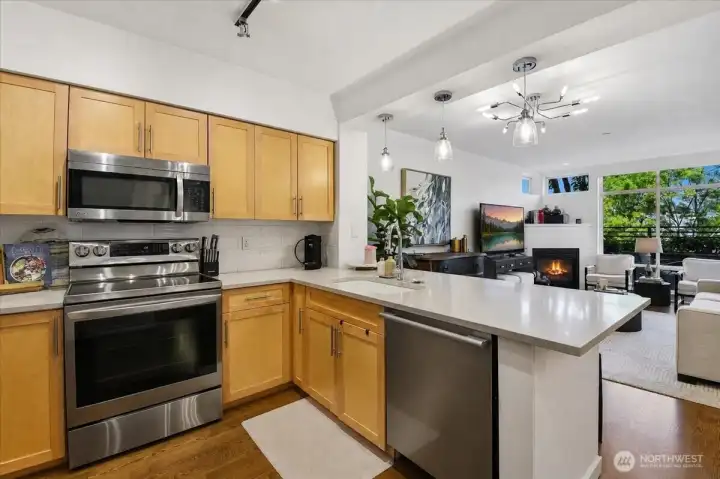 Kitchen features stainless steel appliance package with brand new Range.